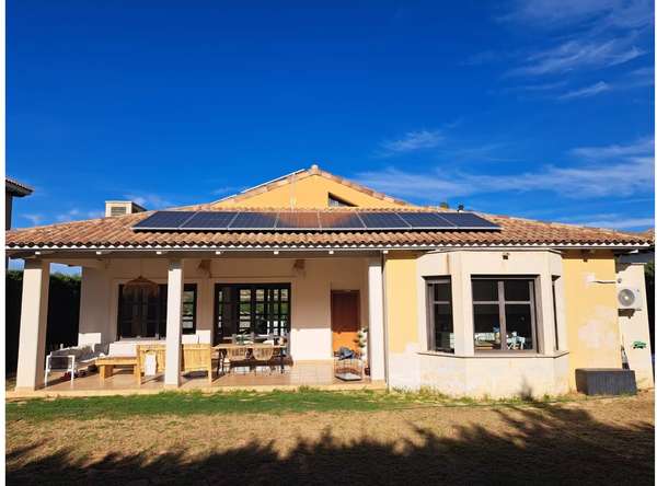 Chalet con paneles solares y jardín